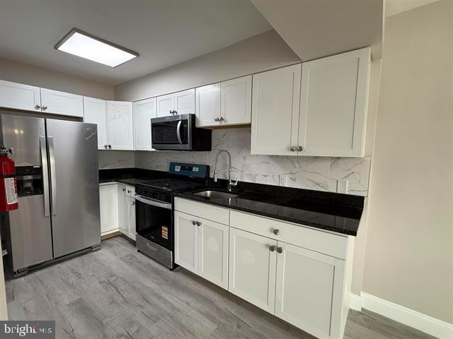 1964 East Oak Road, Unit G2 Vineland, NJ 08361 - Photo 6 of 28 a kitchen with granite countertop a refrigerator and a stove top oven