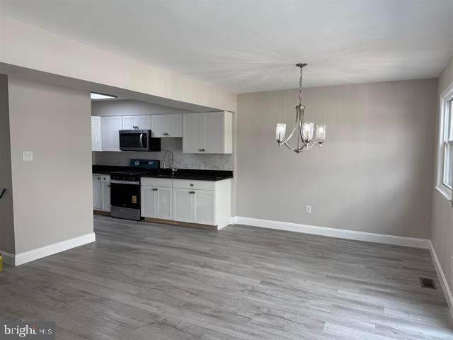 1964 East Oak Road, Unit G2 Vineland, NJ 08361 - Photo 7 of 28 a view of a kitchen with a sink wooden cabinets and stainless steel appliances