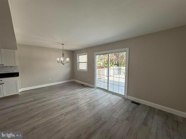 1964 East Oak Road, Unit G2 Vineland, NJ 08361 - Photo 8 of 28 an empty room with wooden floor and windows