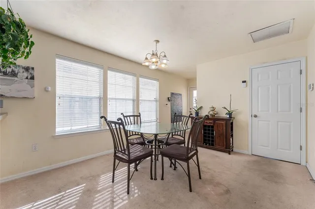 a view of a dining room with furniture and window