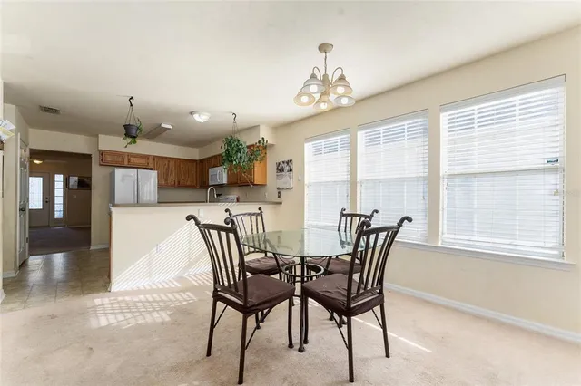 a view of a dining room with furniture window and outside view