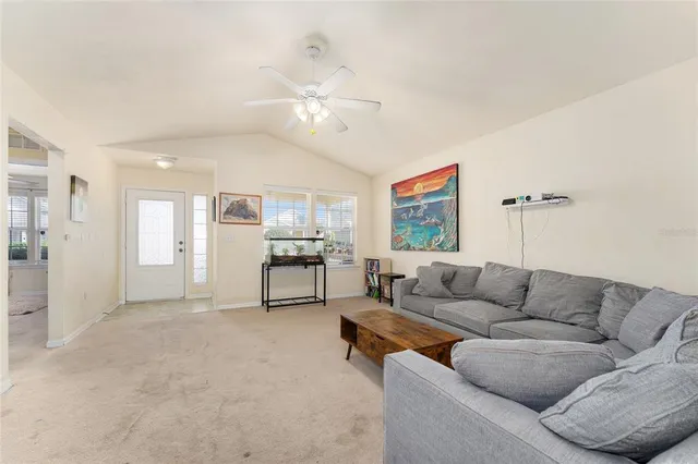 a living room with furniture and kitchen view