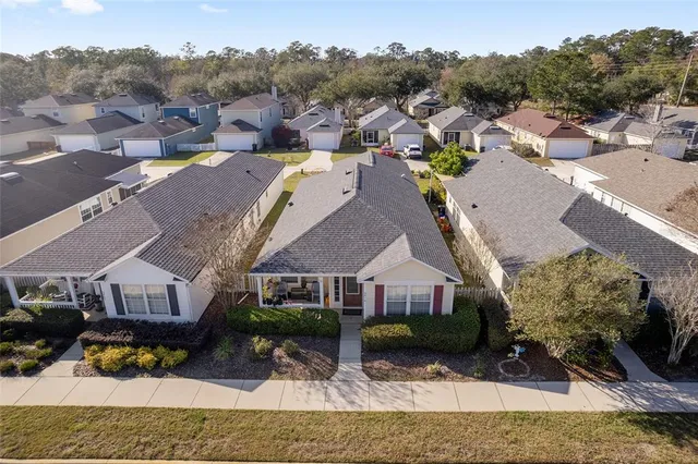 a view of multiple houses with a big yard