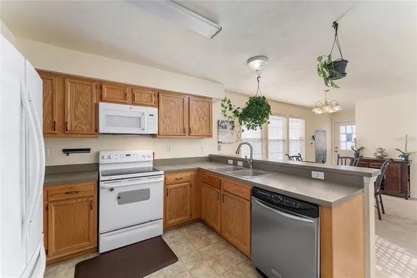 a kitchen with a sink a stove a microwave and cabinets