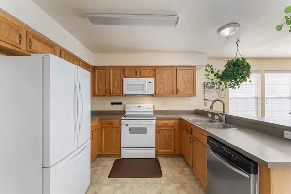 a kitchen with a sink stove and refrigerator