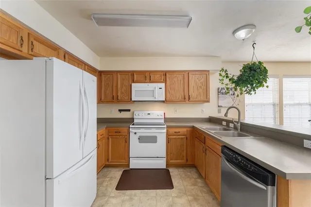 a kitchen with a sink stove and refrigerator