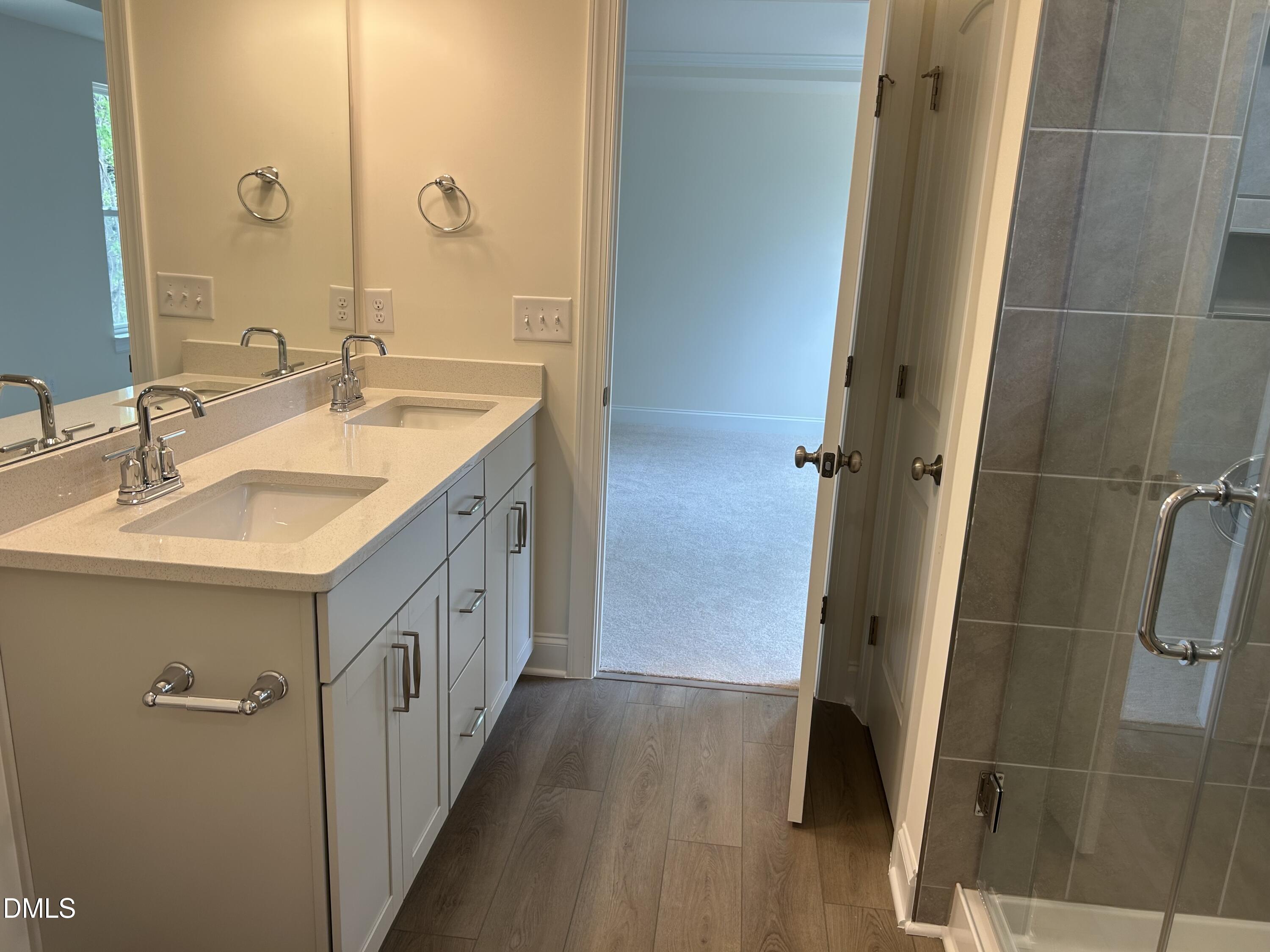 2023 Seneca Road Raleigh, NC 27604 - Photo 13 of 18 a bathroom with a double vanity sink and a mirror