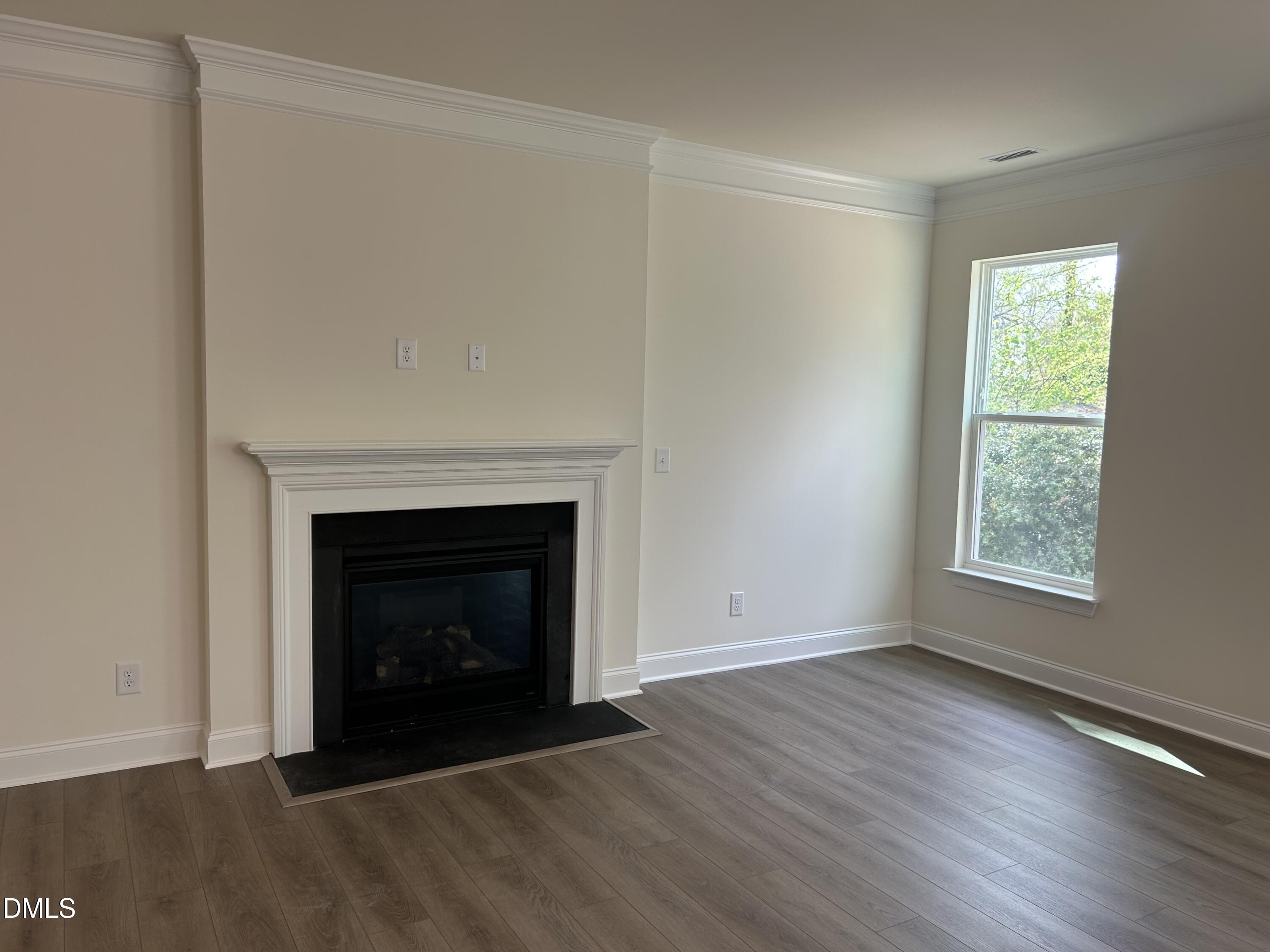 2023 Seneca Road Raleigh, NC 27604 - Photo 5 of 18 a view of an empty room with wooden floor and a fireplace