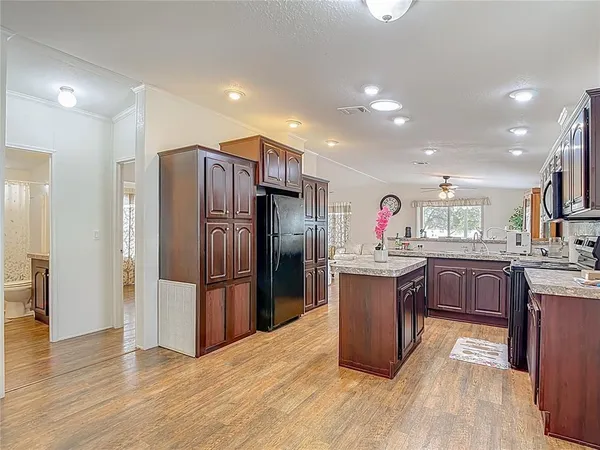 a kitchen with stainless steel appliances granite countertop a refrigerator and cabinets