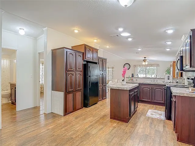 a kitchen with stainless steel appliances granite countertop a sink stove and cabinets
