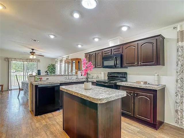 a kitchen with stainless steel appliances granite countertop a refrigerator and cabinets
