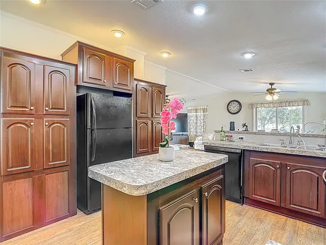 a kitchen with granite countertop cabinets stainless steel appliances and a counter space