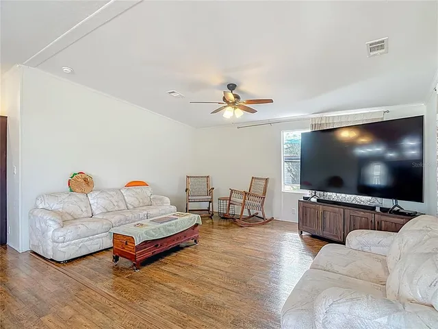 an empty room with wooden floor and closet