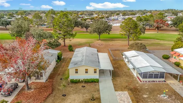 a backyard of a house with plants and wooden fence