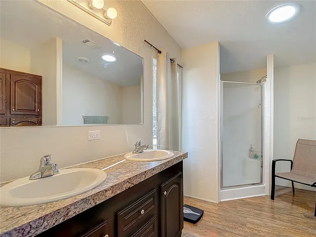 a view of a patio with chairs and floor to ceiling window next to a yard