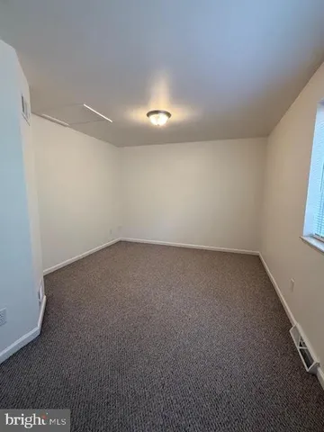 an empty room with a empty space and window