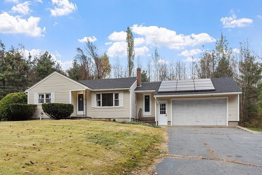 663 Sterling Road Lancaster, MA 01523 - Photo 1 of 33 a front view of a house with a yard and garage