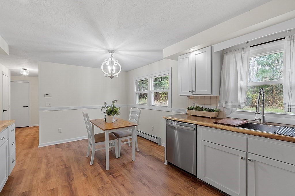 663 Sterling Road Lancaster, MA 01523 - Photo 19 of 33 a kitchen with a dining table chairs and window