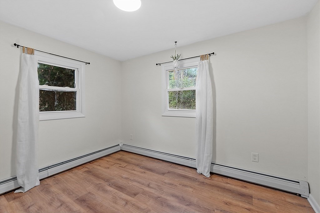 663 Sterling Road Lancaster, MA 01523 - Photo 27 of 33 an empty room with wooden floor and windows