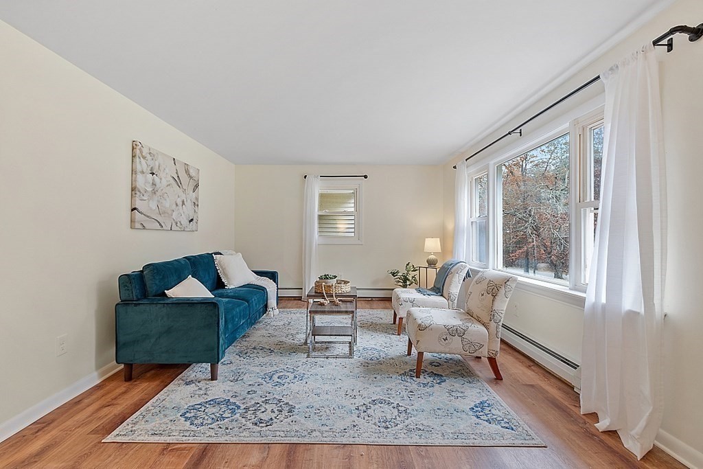 663 Sterling Road Lancaster, MA 01523 - Photo 6 of 33 a living room with furniture and a rug