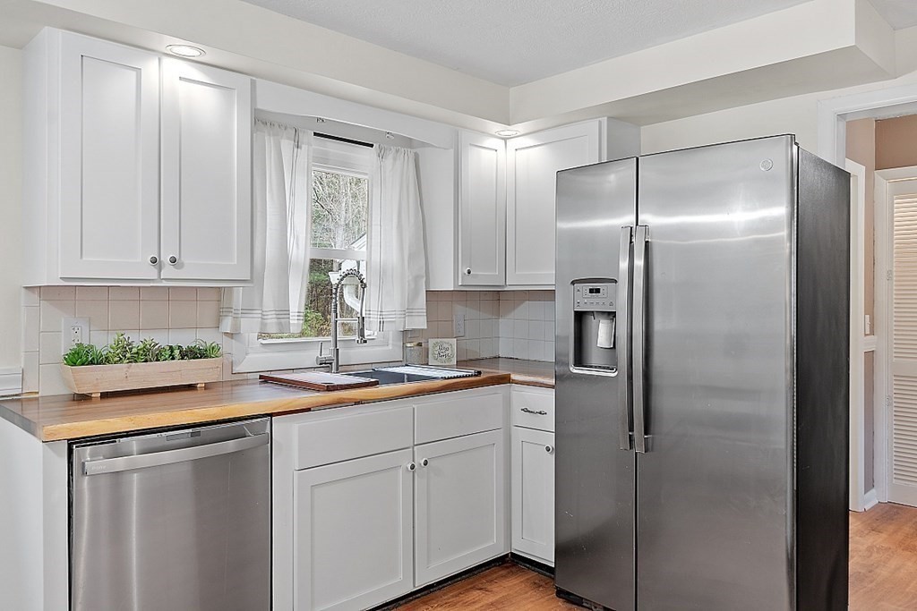 663 Sterling Road Lancaster, MA 01523 - Photo 8 of 33 a kitchen with stainless steel appliances granite countertop a refrigerator and a sink