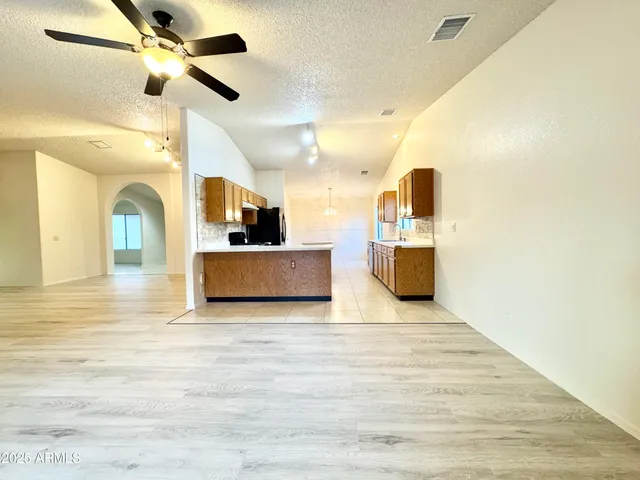 a view of a kitchen with a sink and a refrigerator