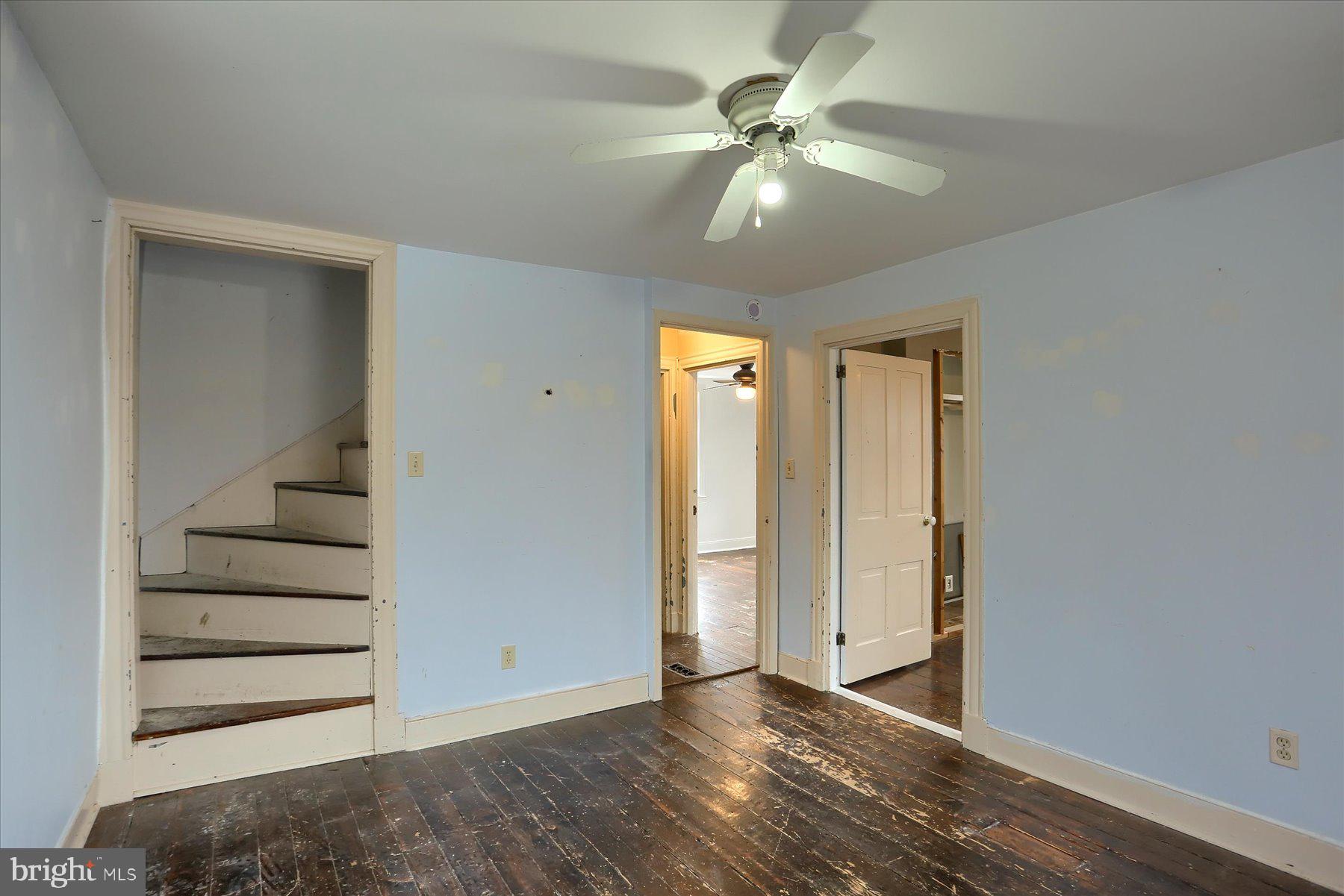 826 Pinetown Road Lewisberry, PA 17339 - Photo 13 of 31 an empty room with wooden floor fan and windows