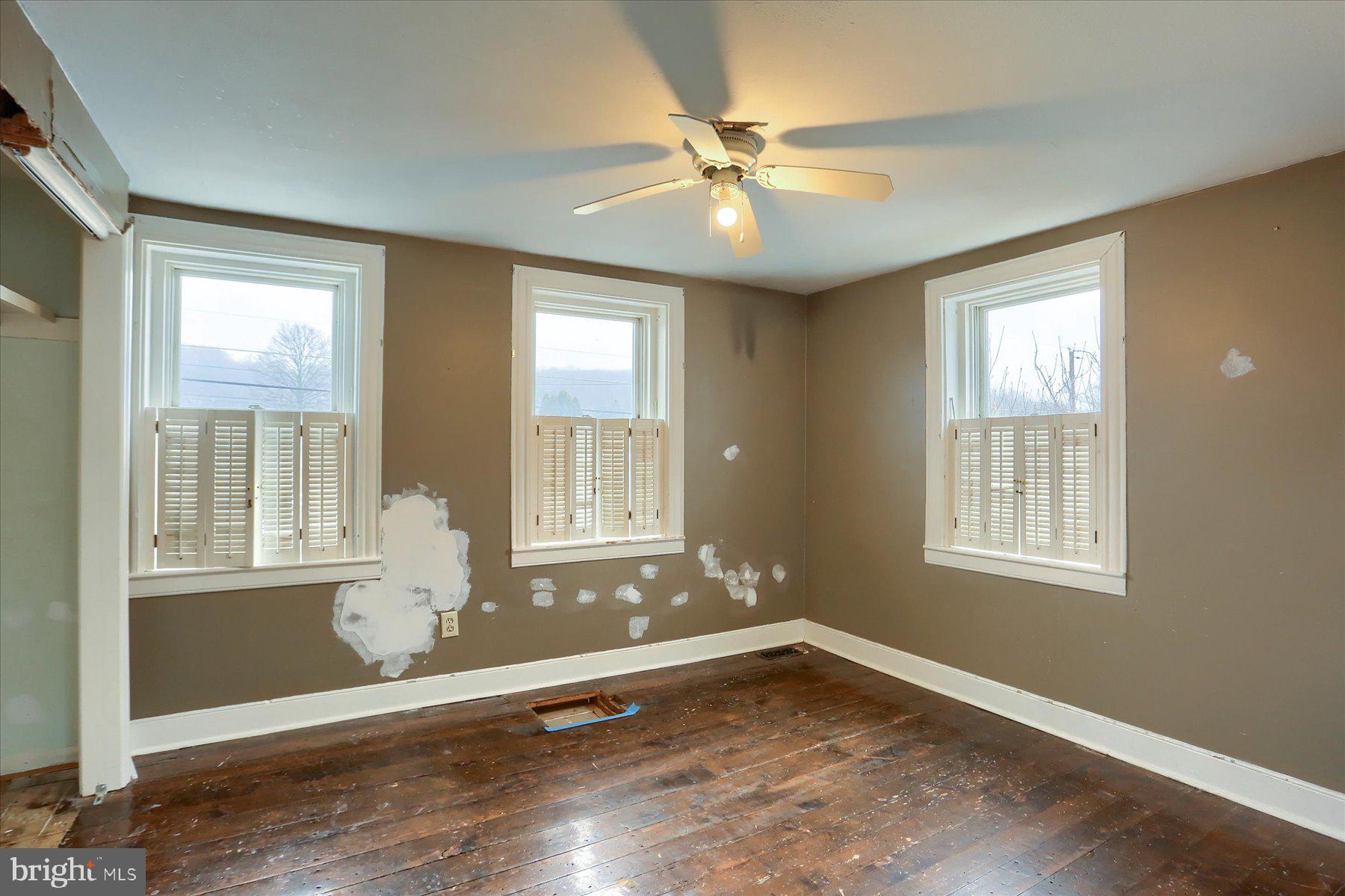 826 Pinetown Road Lewisberry, PA 17339 - Photo 14 of 31 a view of an empty room with wooden floor and a window