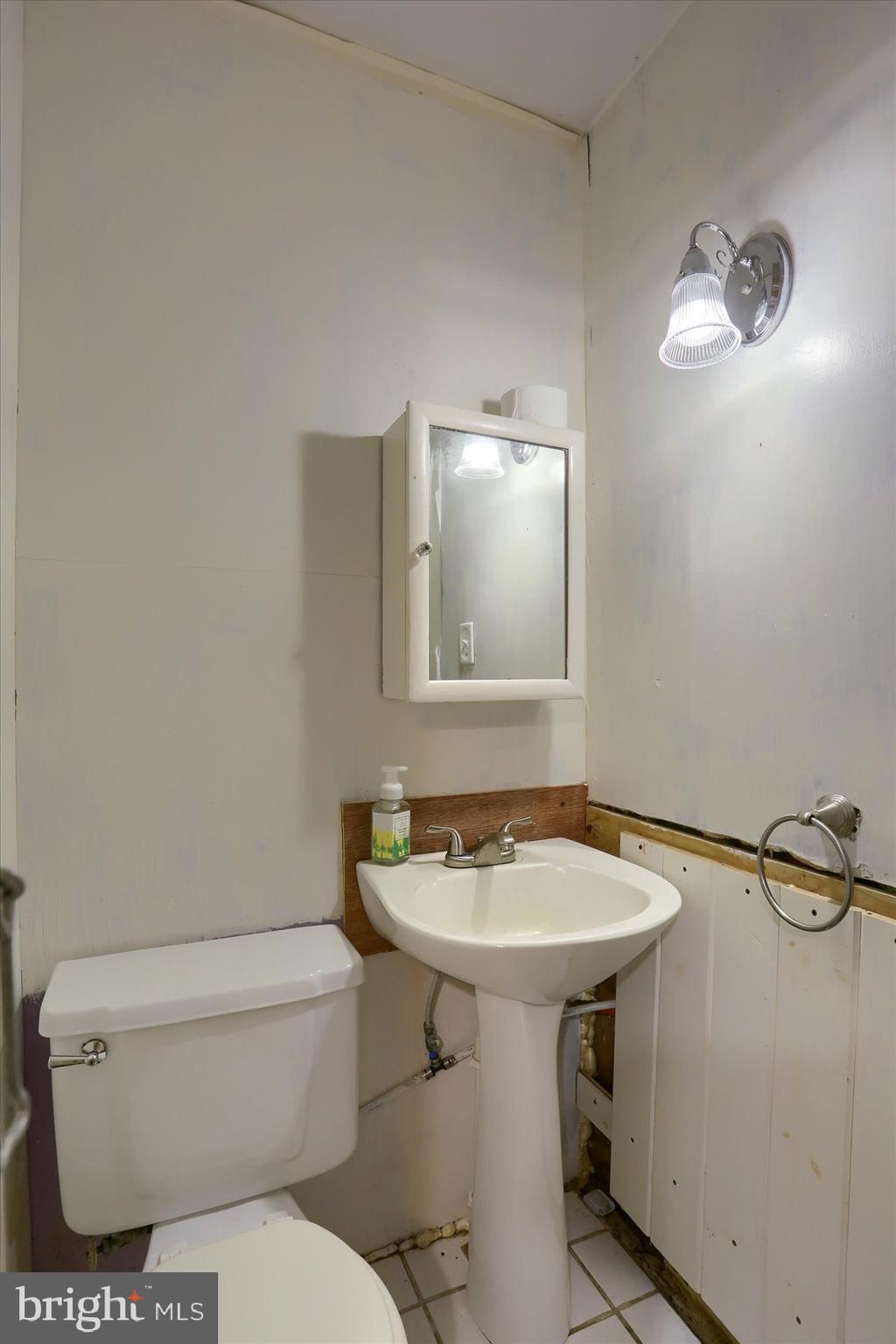 826 Pinetown Road Lewisberry, PA 17339 - Photo 18 of 31 a bathroom with a sink a toilet and mirror
