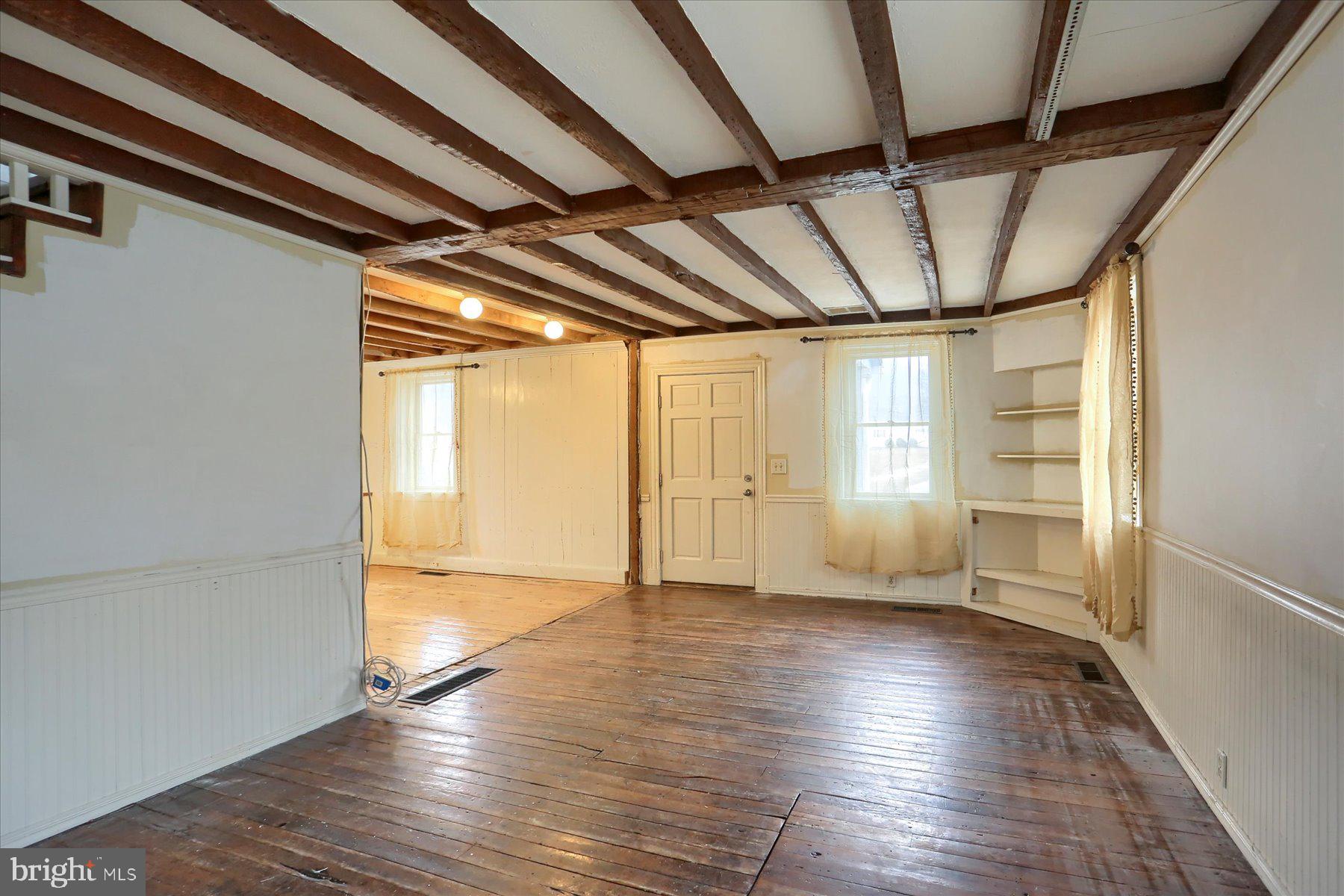 826 Pinetown Road Lewisberry, PA 17339 - Photo 4 of 31 a view of an empty room with wooden floor and a window