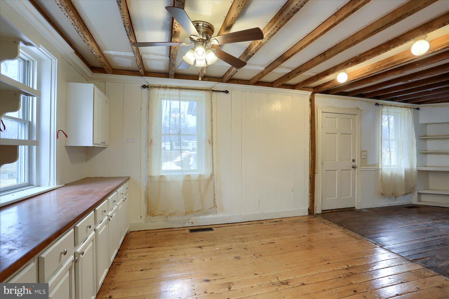 826 Pinetown Road Lewisberry, PA 17339 - Photo 9 of 31 a view of an empty room with wooden floor and a window
