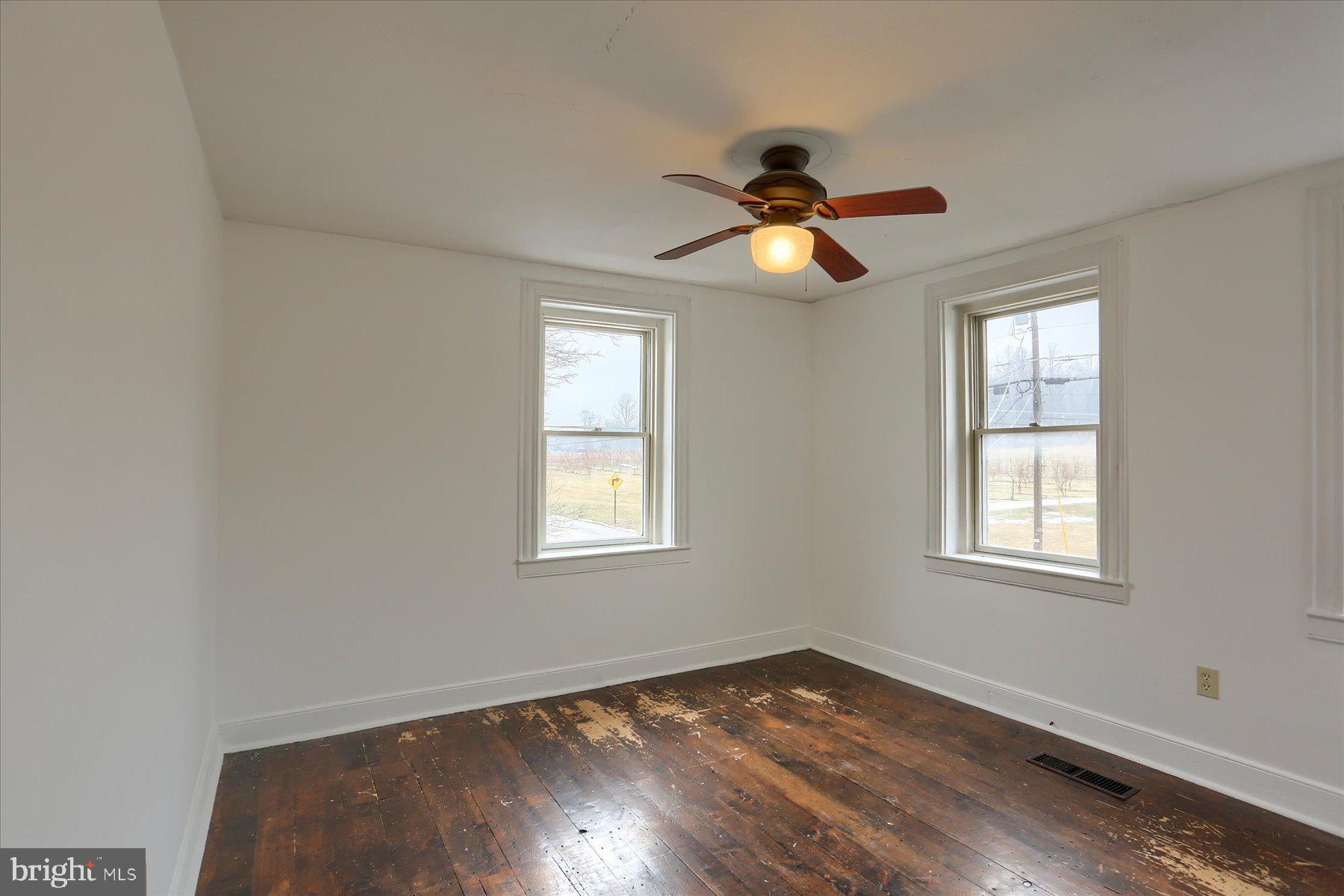 826 Pinetown Road Lewisberry, PA 17339 - Photo 10 of 31 a view of empty room with wooden floor and fan