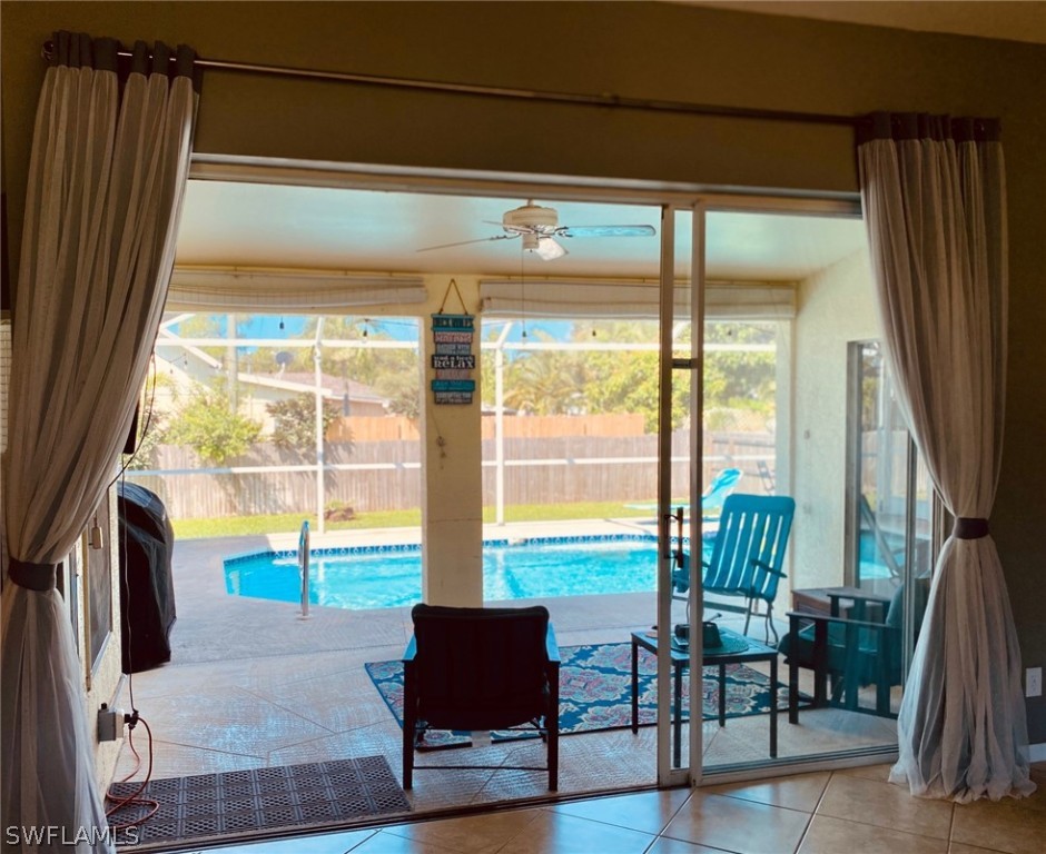 18566 Violet Road Fort Myers, FL 33967 - Photo 8 of 30 a living room with furniture and floor to ceiling windows