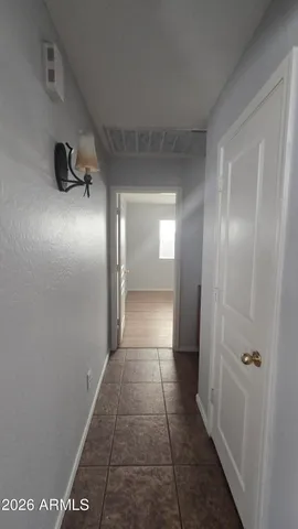 a view of hallway with a large window and a mirror
