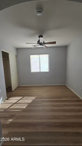 a view of a room with wooden floor and window