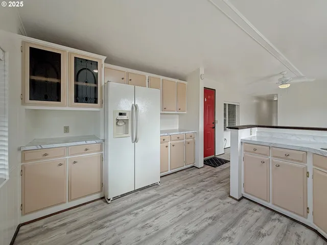 a kitchen with sink cabinets and wooden floor