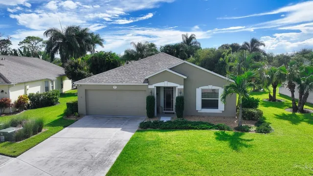 a front view of house with yard and green space
