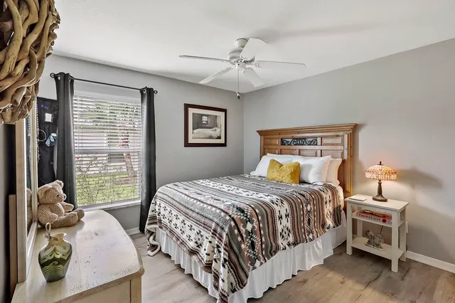 a bedroom with a bed and wooden floor