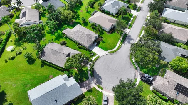 a front view of a house with a garden and yard