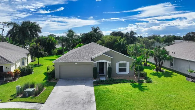 an aerial view of a house with garden space and street view