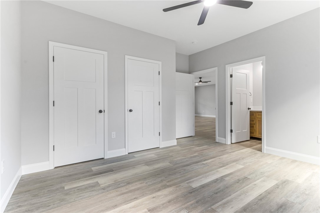 1115 Marshall Road Anderson, SC 29626 - Photo 20 of 35 Smooth vinyl plank flooring pairs with clean white trim in this versatile bedroom space.