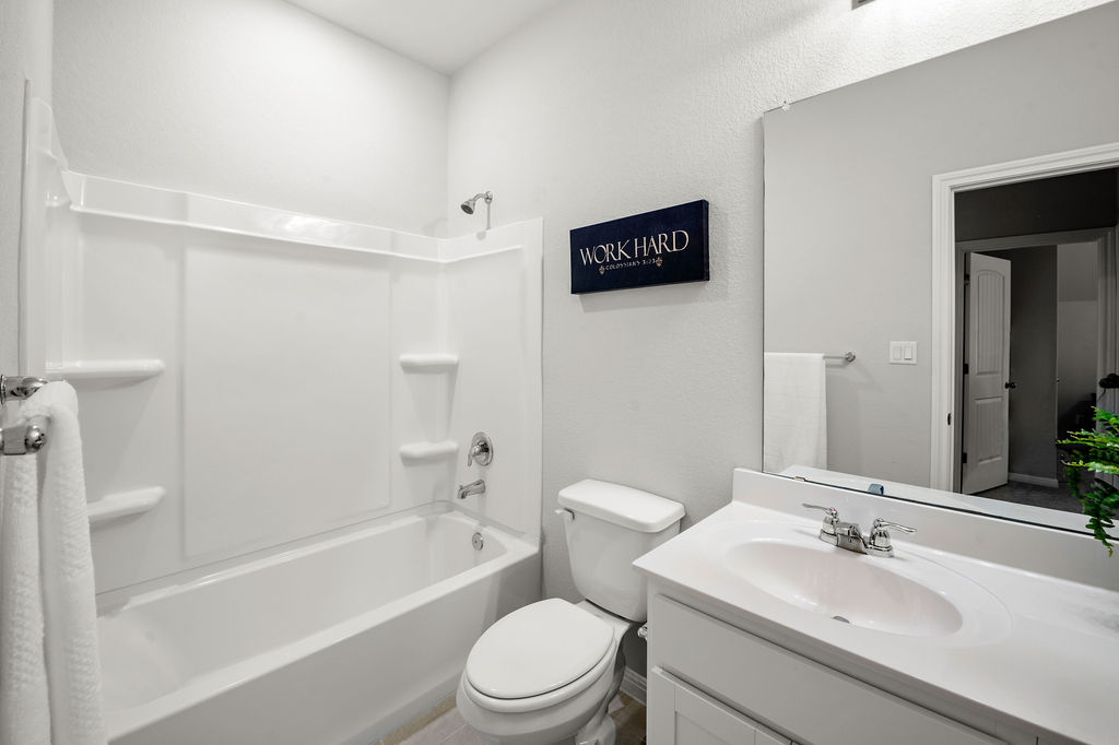 2417 Roosevelt Road Leander, TX 78641 - Photo 31 of 40 a bathroom with a sink a toilet and shower