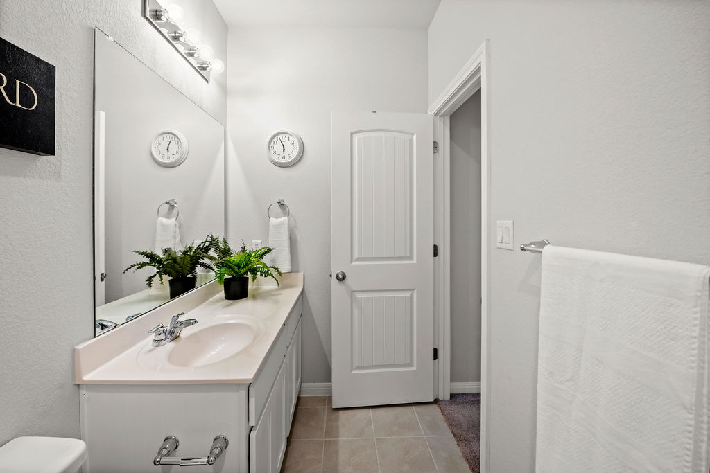 2417 Roosevelt Road Leander, TX 78641 - Photo 32 of 40 a bathroom with a sink and a mirror