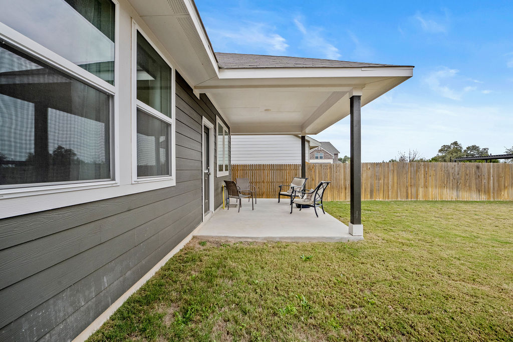 2417 Roosevelt Road Leander, TX 78641 - Photo 38 of 40 a view of a patio with a table chairs and wooden fence