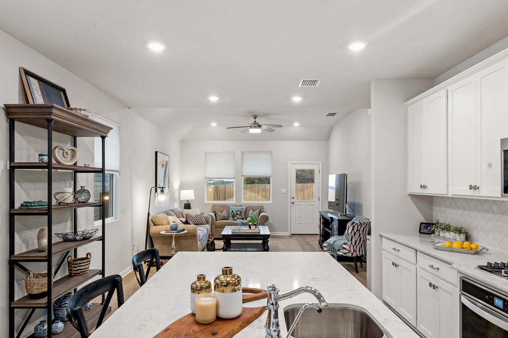 2417 Roosevelt Road Leander, TX 78641 - Photo 5 of 40 a living room with furniture a rug and a chandelier