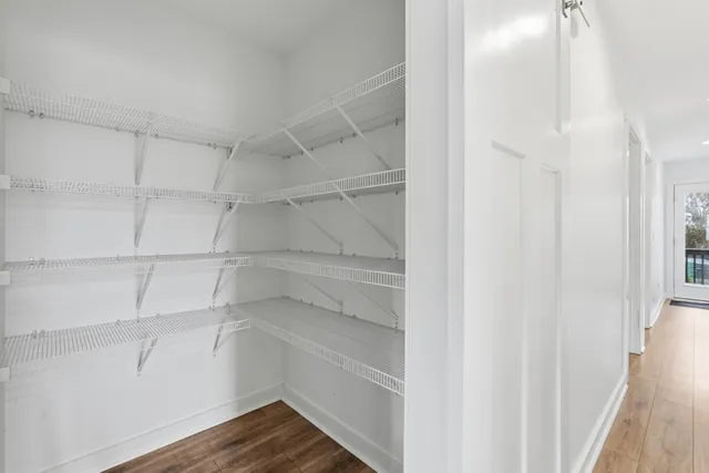 a view of walk in closet with empty racks