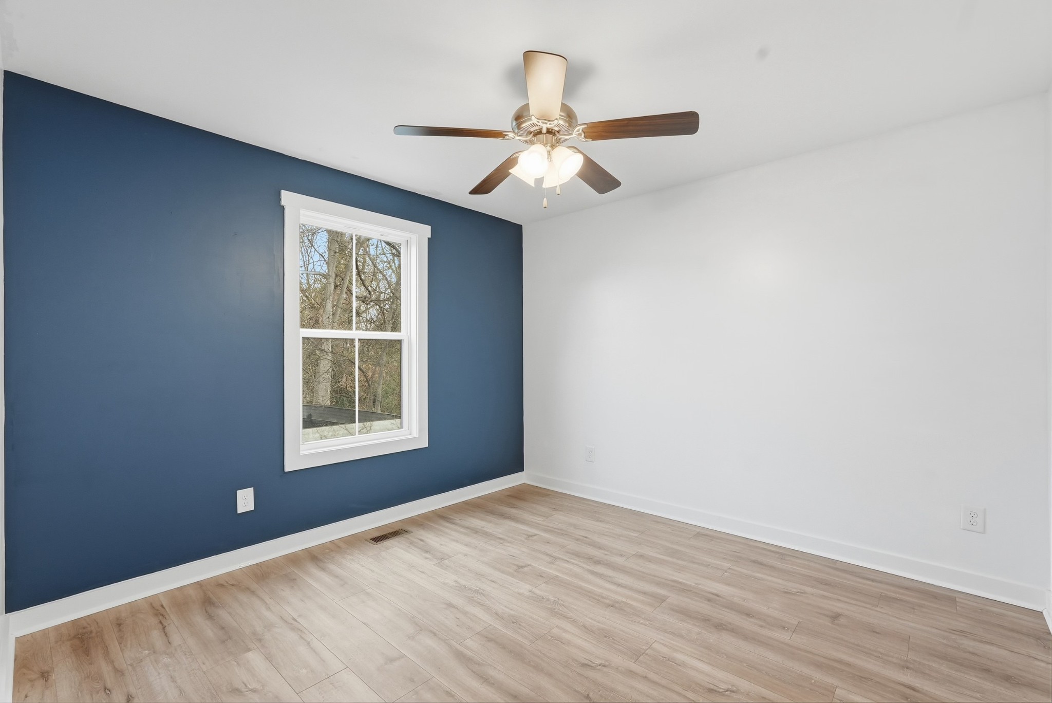 113 11th Avenue West Springfield, TN 37172 - Photo 26 of 27 an empty room with wooden floor chandelier fan and windows