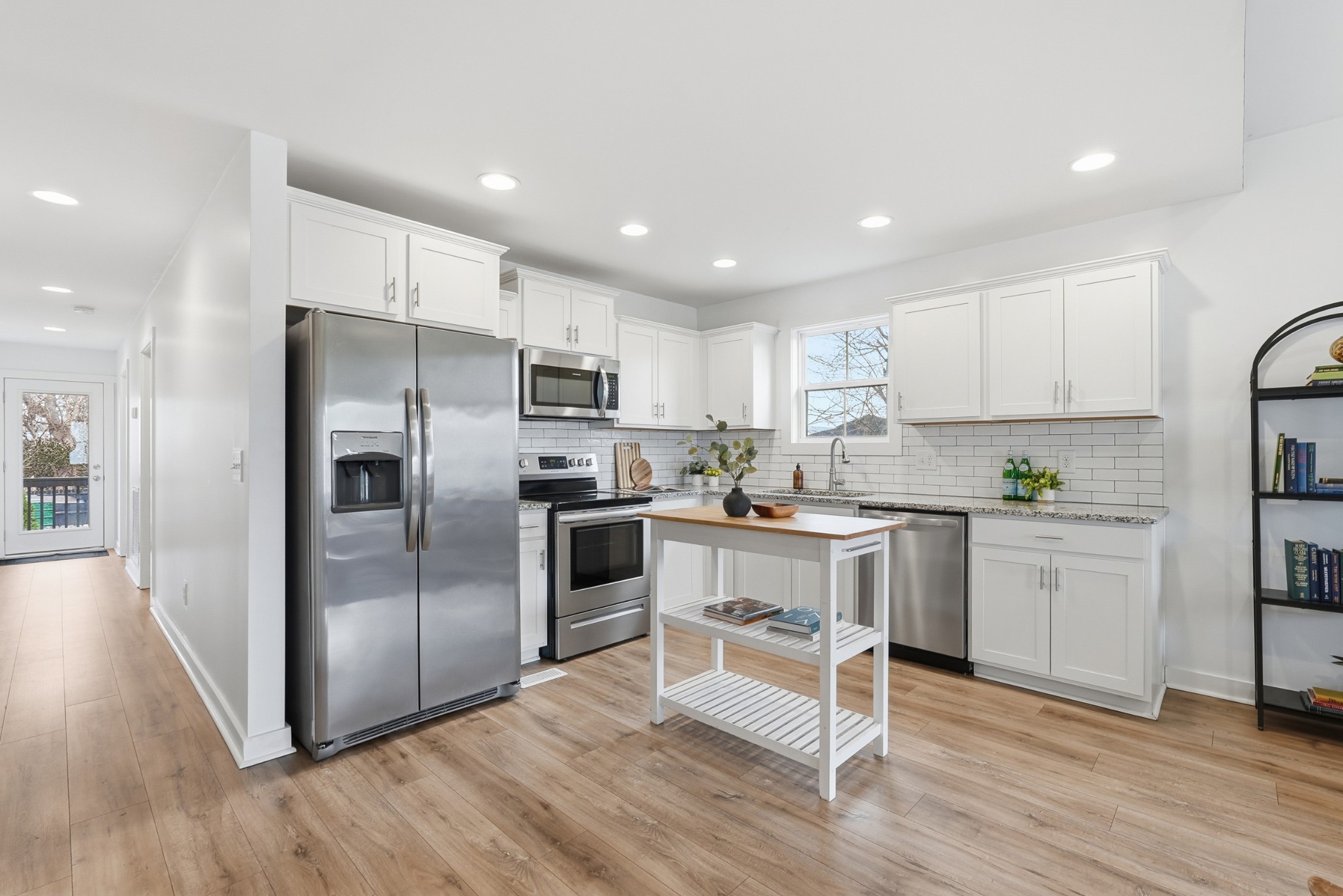 113 11th Avenue West Springfield, TN 37172 - Photo 8 of 27 a kitchen with kitchen island white cabinets and stainless steel appliances