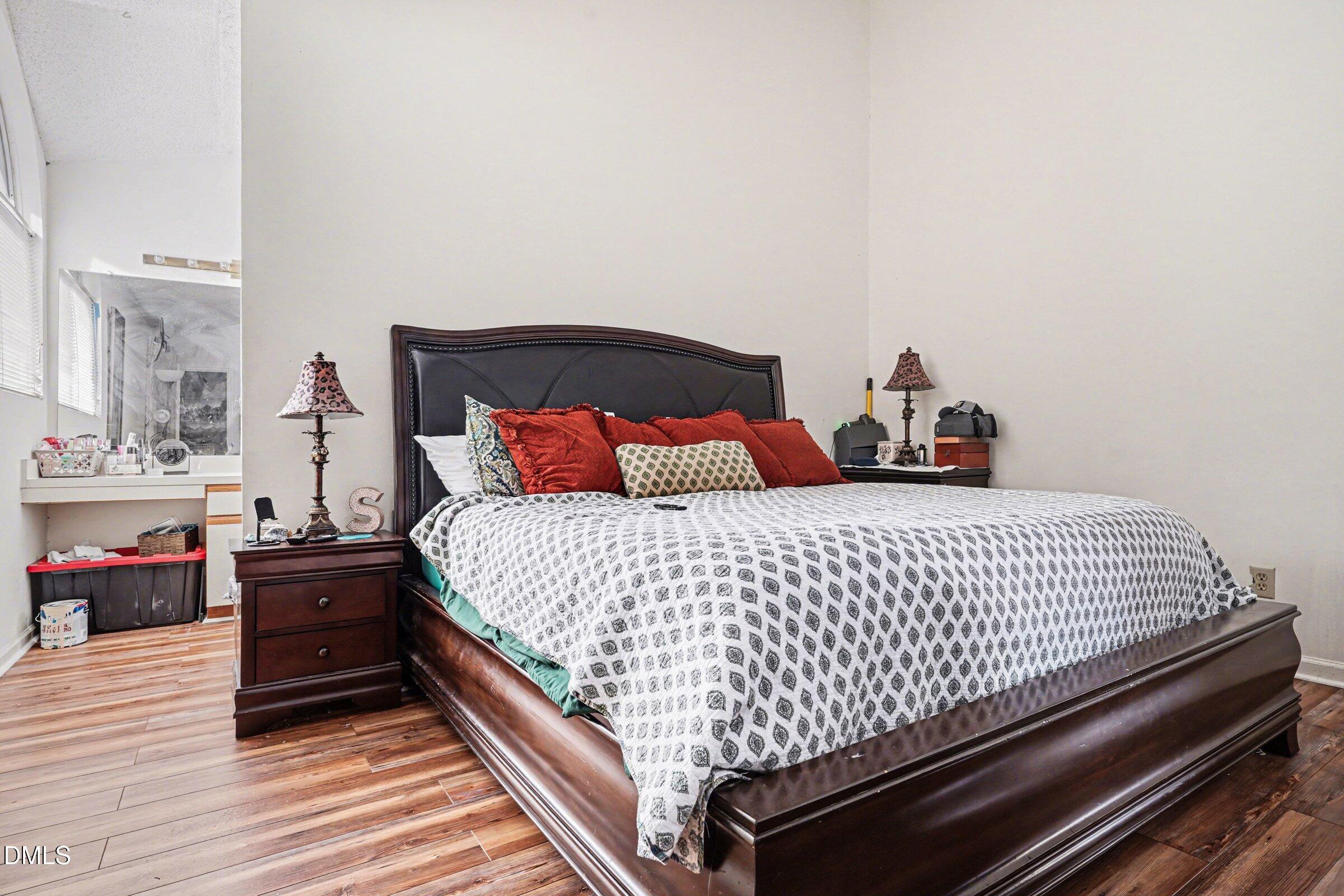 3806 Grey Harbor Drive, Unit 204 Raleigh, NC 27616 - Photo 13 of 18 a bedroom with a bed and wooden floor