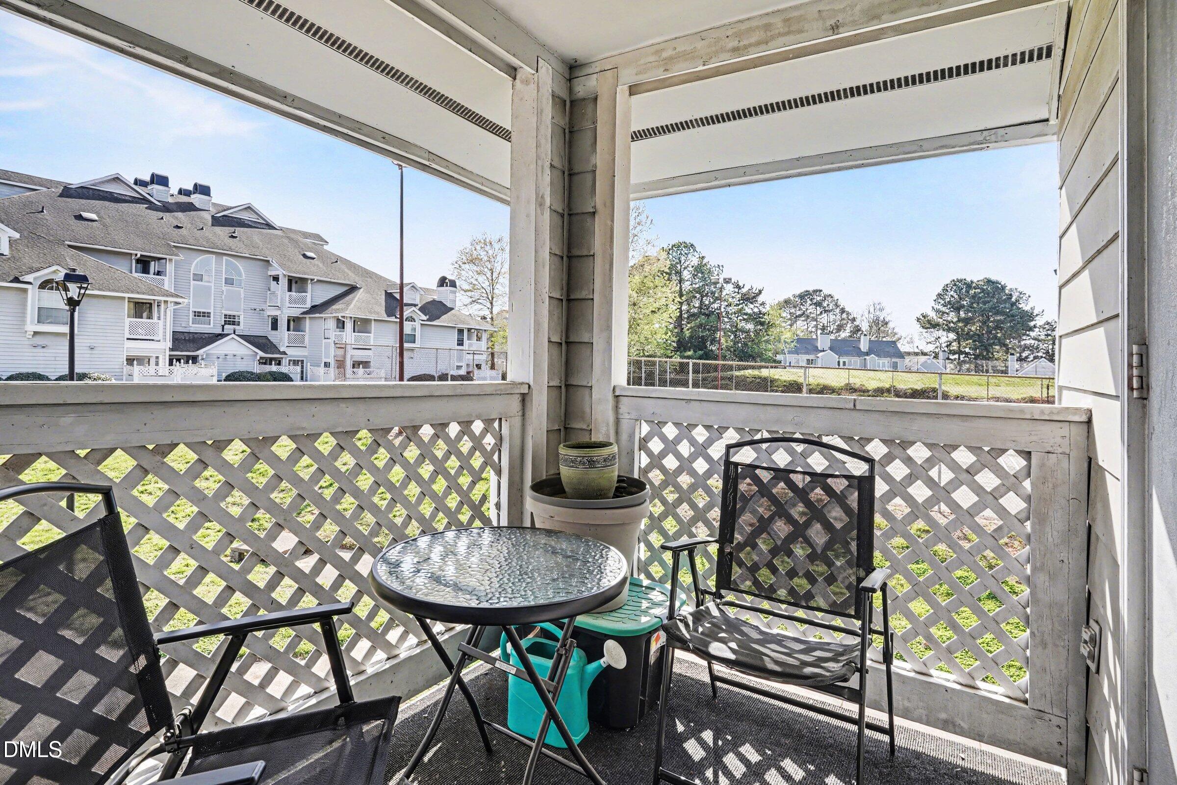 3806 Grey Harbor Drive, Unit 204 Raleigh, NC 27616 - Photo 14 of 18 a view of a chairs and table in the balcony